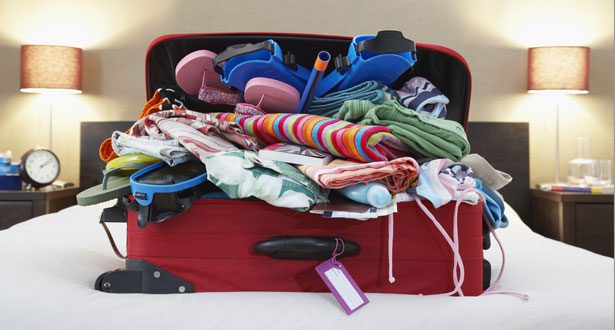 a suitcase full of clothes and sandals