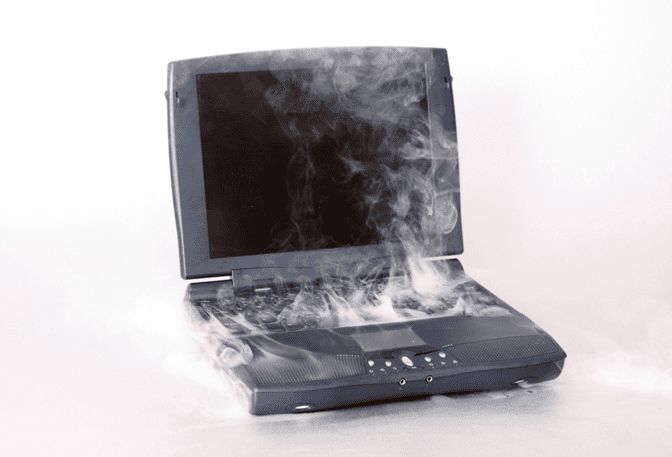 a laptop with smoke coming out of it