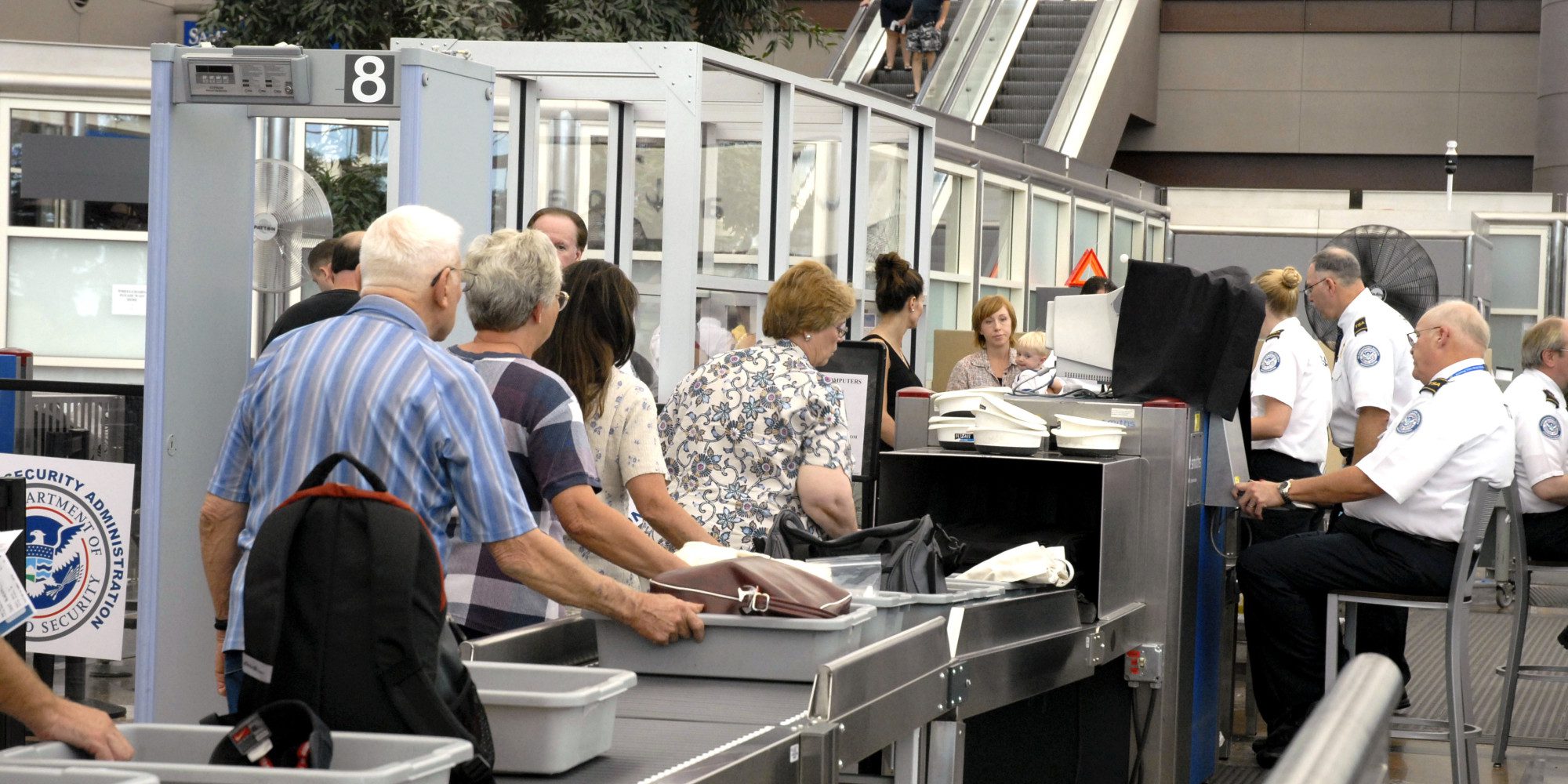 people at an airport check-in counter