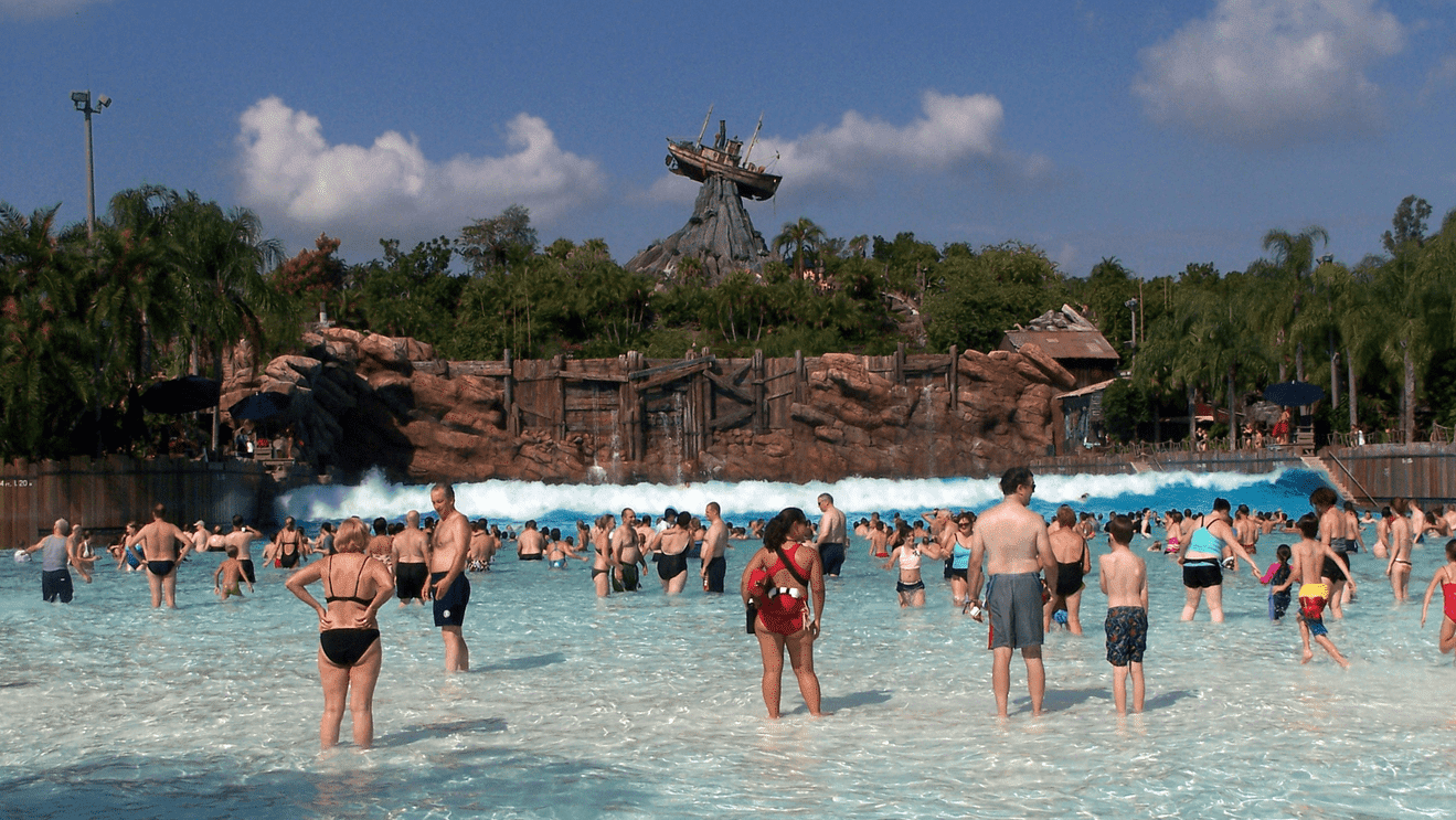 a group of people in a pool with Disney's Typhoon Lagoon in the background