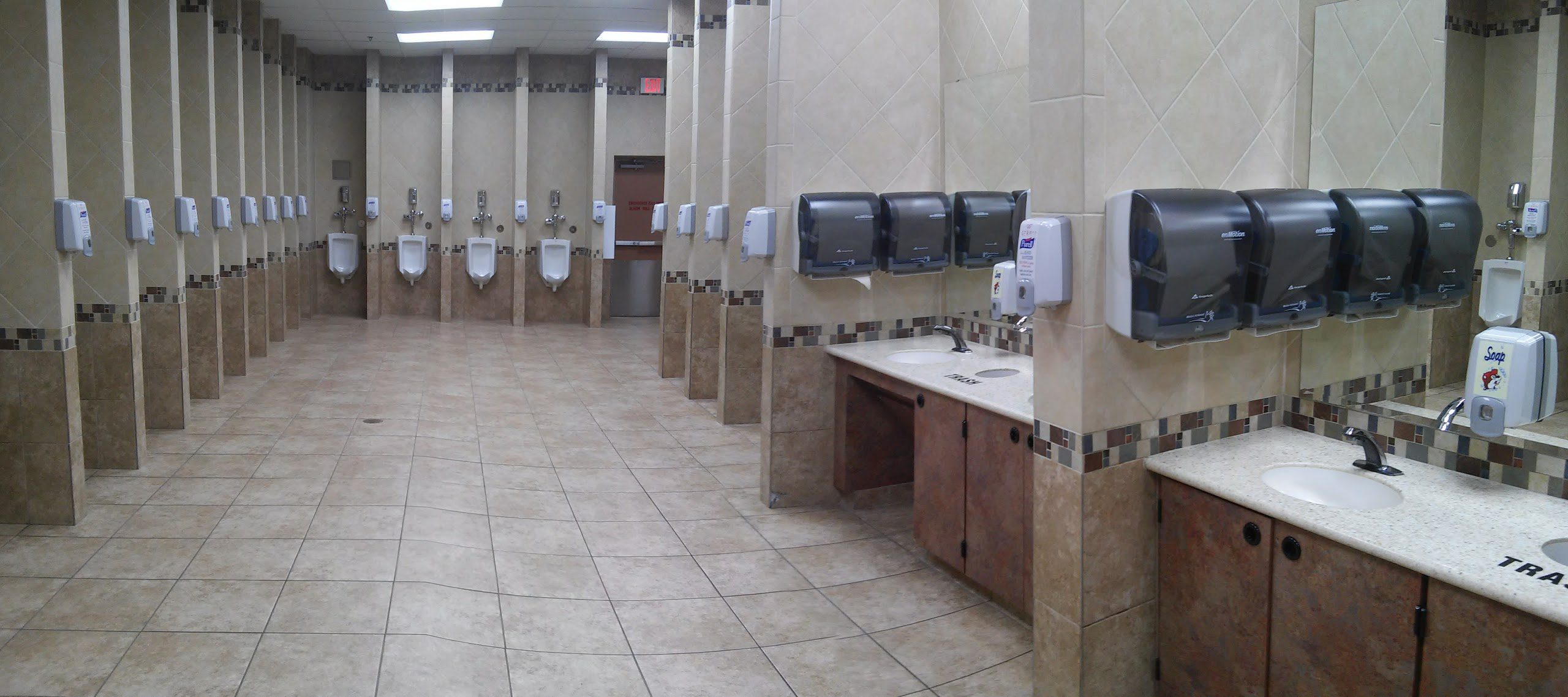 a bathroom with urinals and sinks