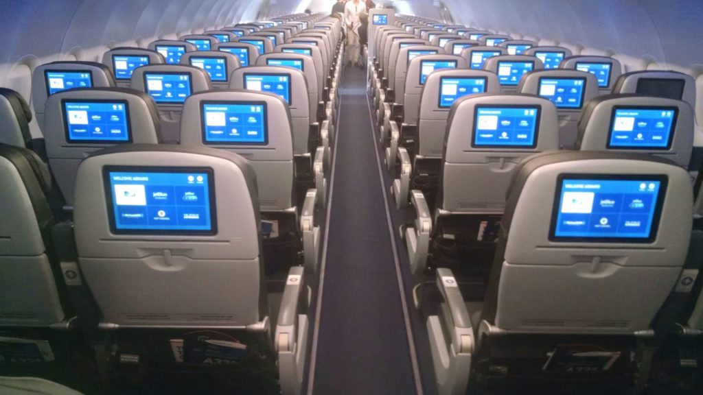 rows of seats with screens on the back