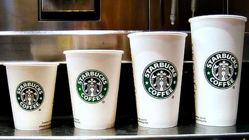 a group of white cups with green logos