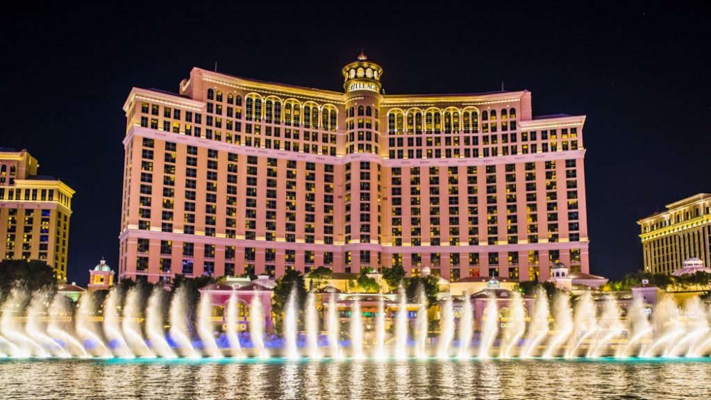 a large building with a fountain in front of it with Bellagio in the background