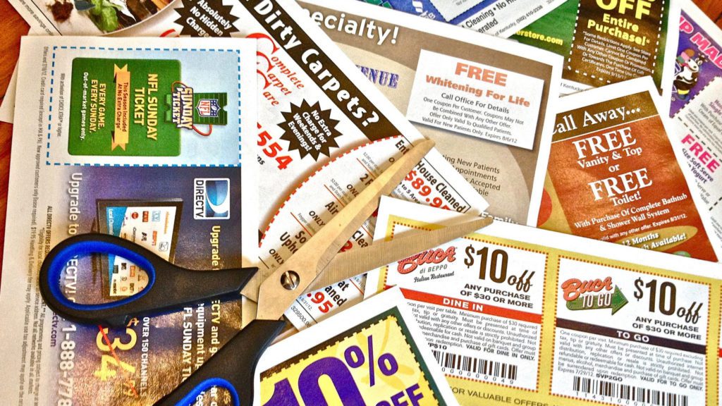 a pile of coupons and scissors