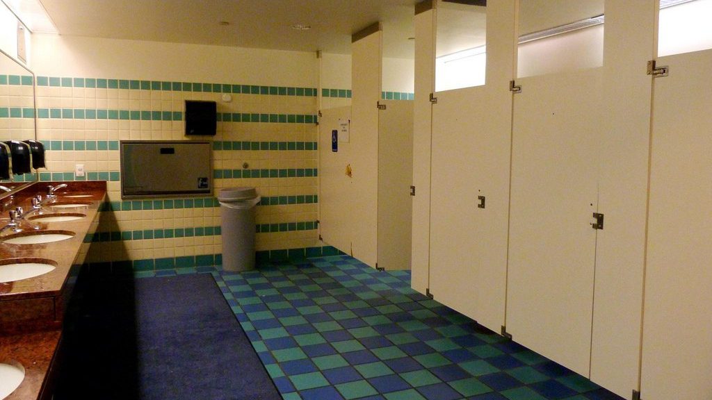 a bathroom with blue and green tiles