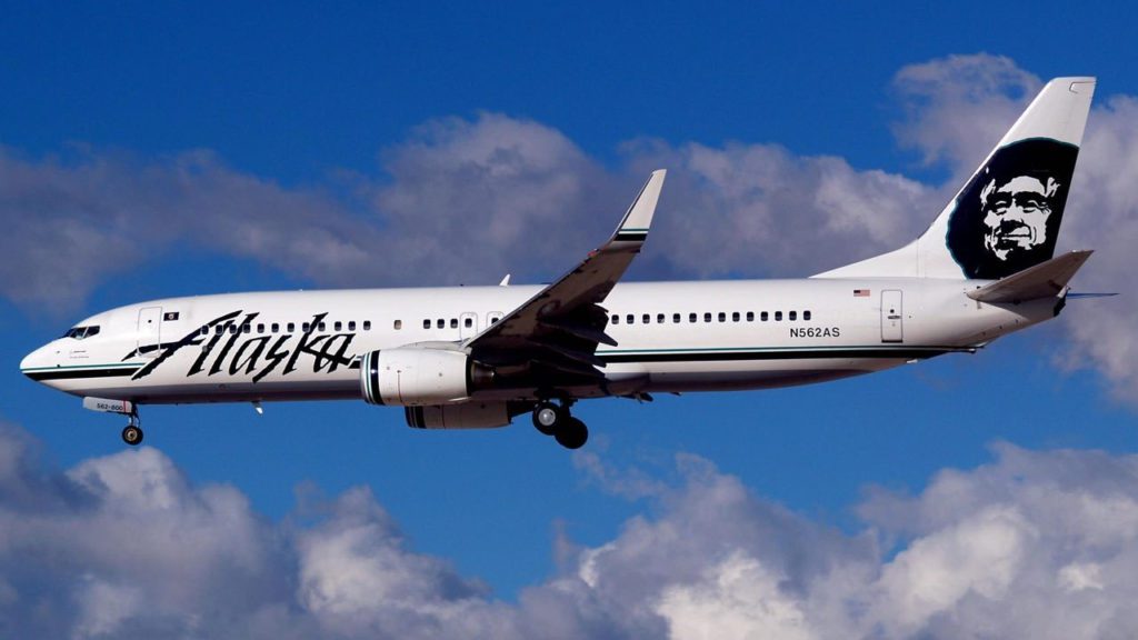 a white airplane flying in the sky