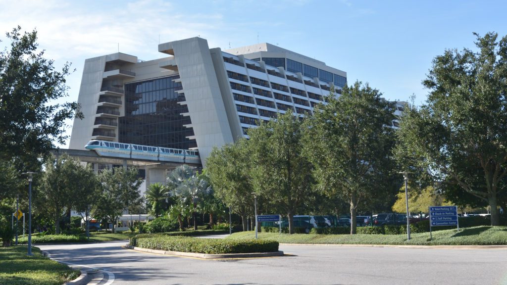 a building with trees and a train going over it