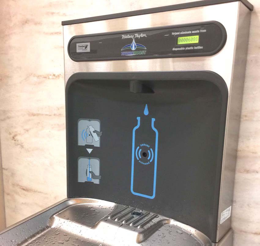 a water fountain with a bottle on the screen