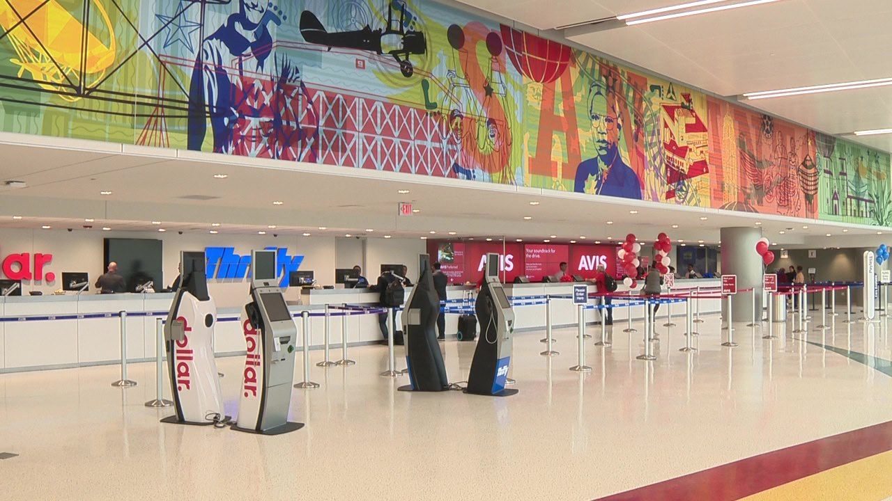 a large airport terminal with a large banner above it