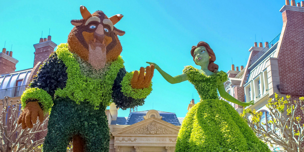 a statue of a woman and a man dressed in a beauty and the beast