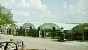 a green building with a green object in the front