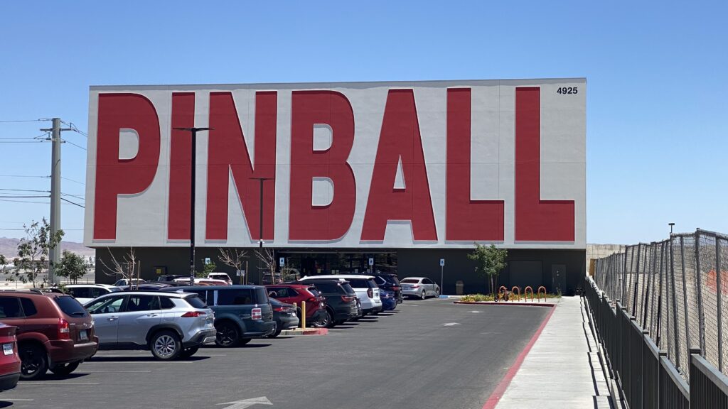 a parking lot with cars parked in front of a large building