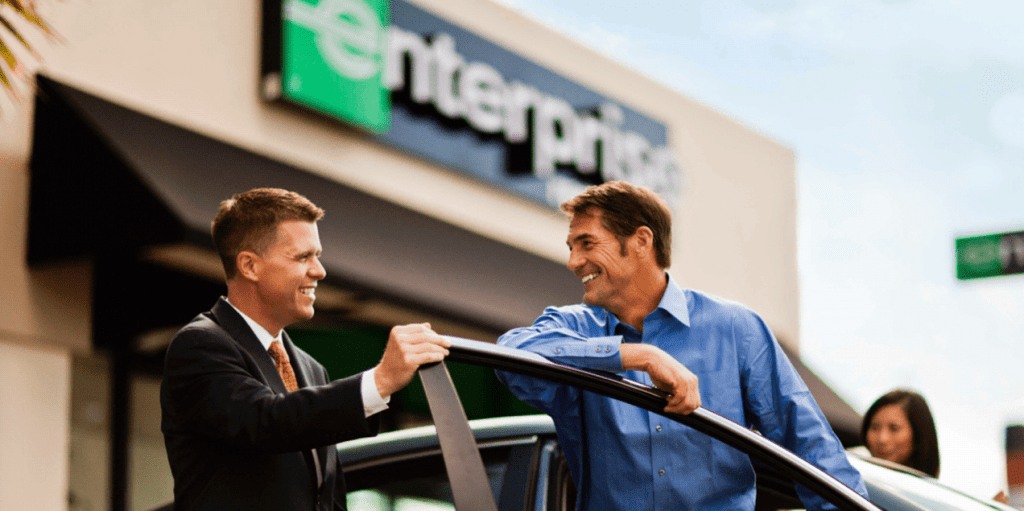 a man holding a car railing