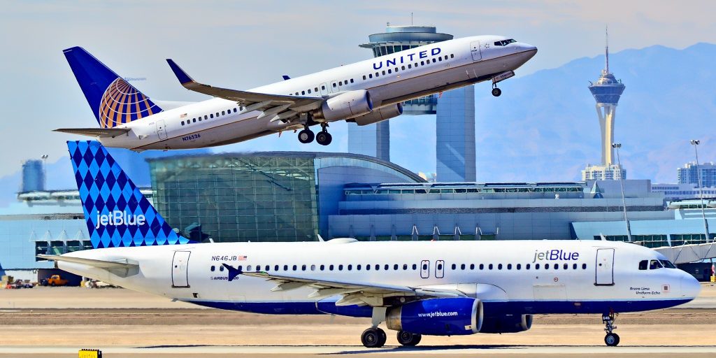 two airplanes taking off from a runway