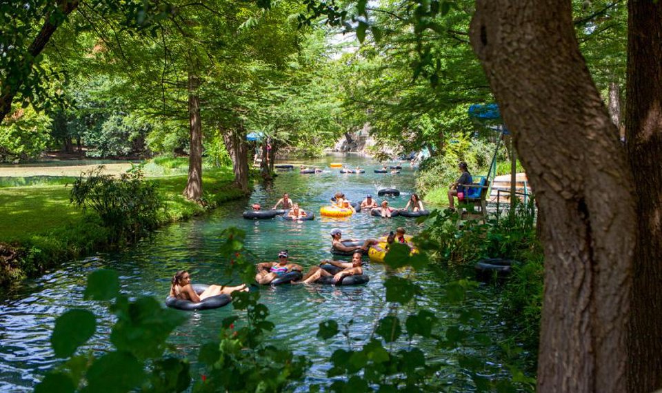 a group of people floating in a river