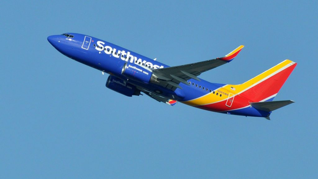 a blue and red airplane in the sky