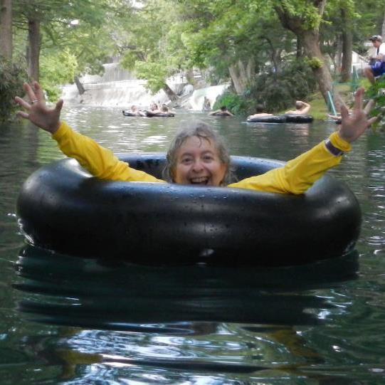 a woman in a black tube in a river