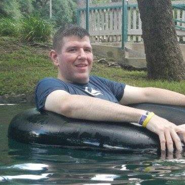 a man sitting on a black tube in water