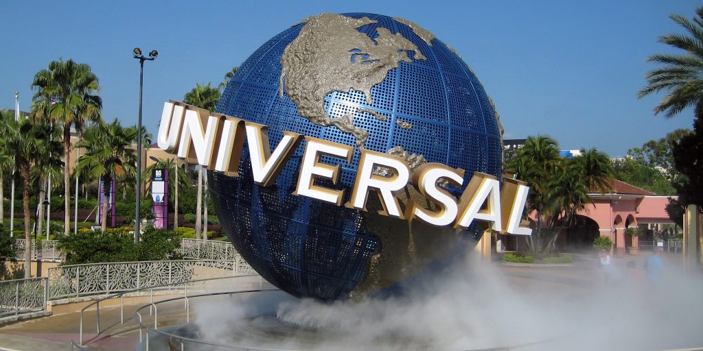 a large globe with a sign in the middle