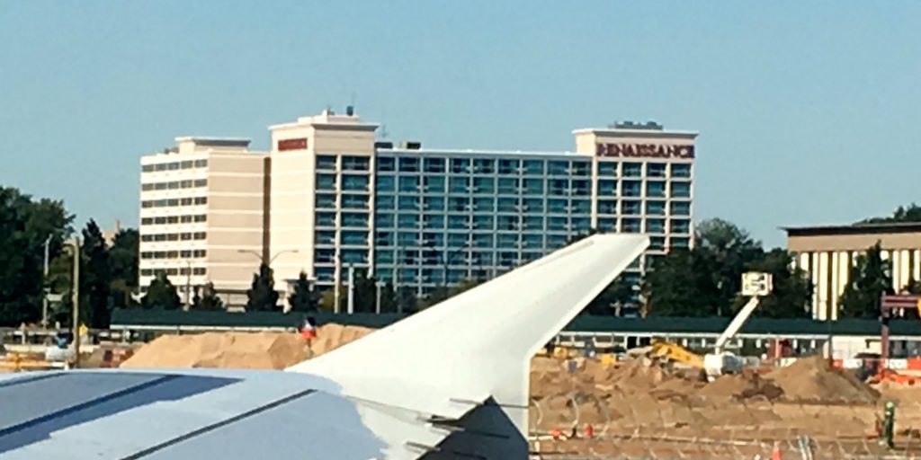 a plane wing in front of a building