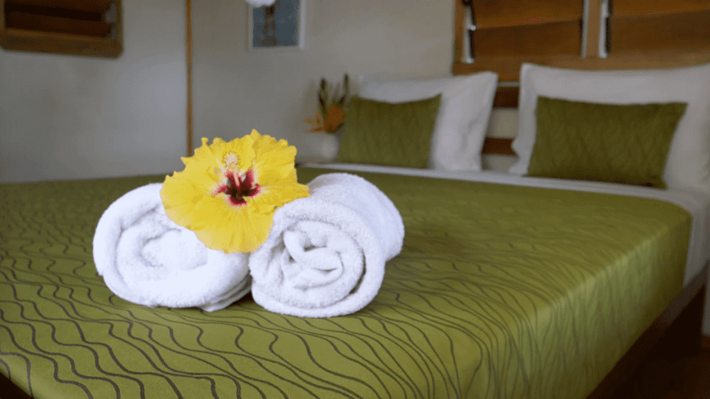 a yellow flower on a bed