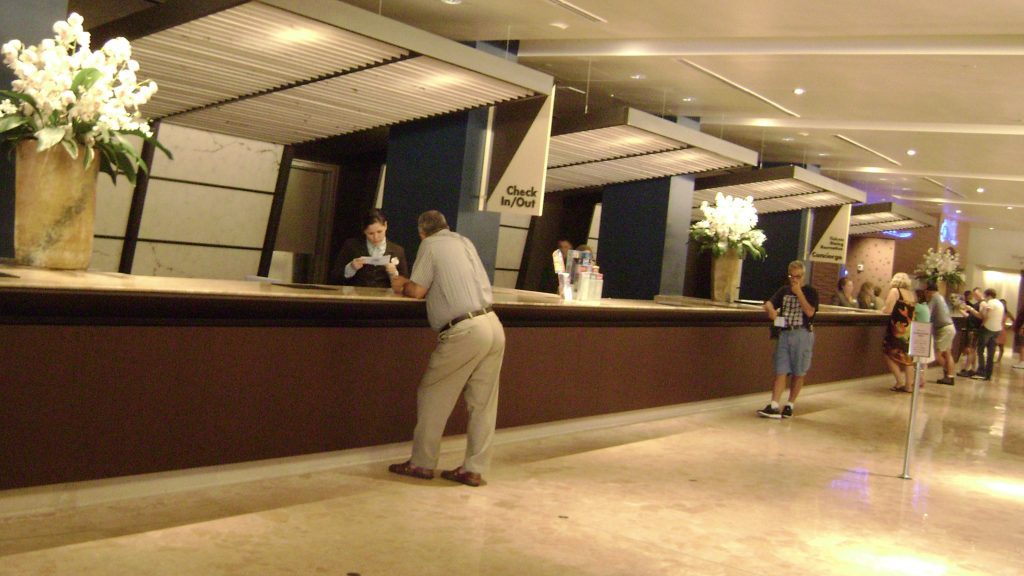 people standing at a counter in a hotel