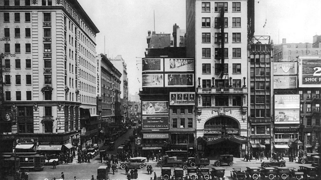 a busy city street with cars and people