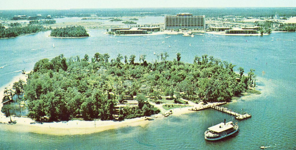 a aerial view of a beach with a boat and trees