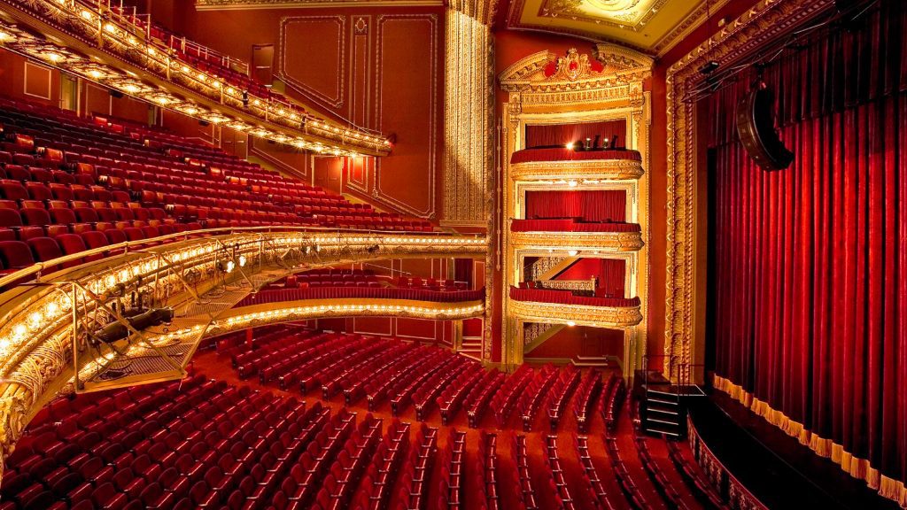 a theater with rows of red seats