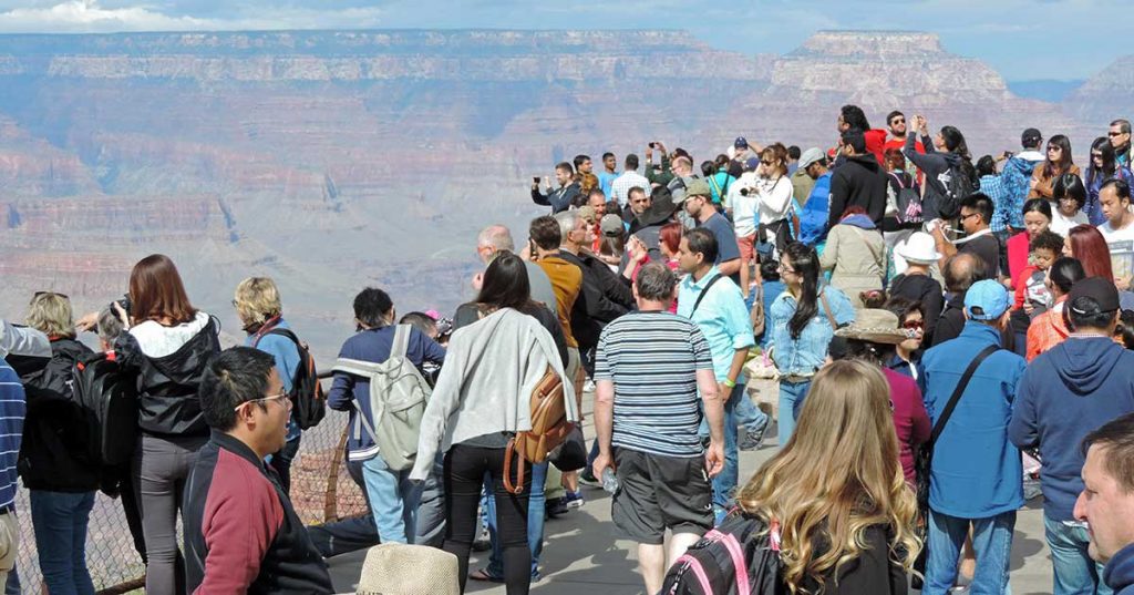 a group of people standing on a ledge