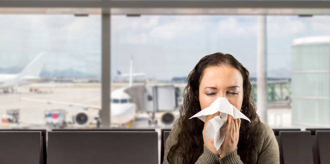 a woman blowing her nose into a tissue