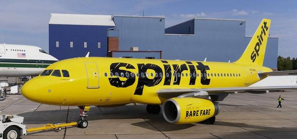 a yellow airplane with black text on it
