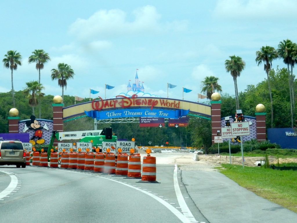 a road with traffic cones and signs on the side