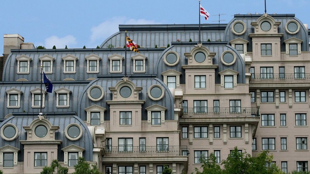 a building with many windows and flags