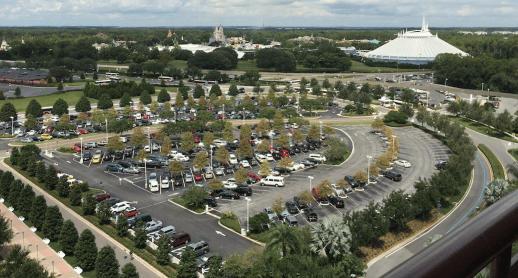 a parking lot with cars and trees