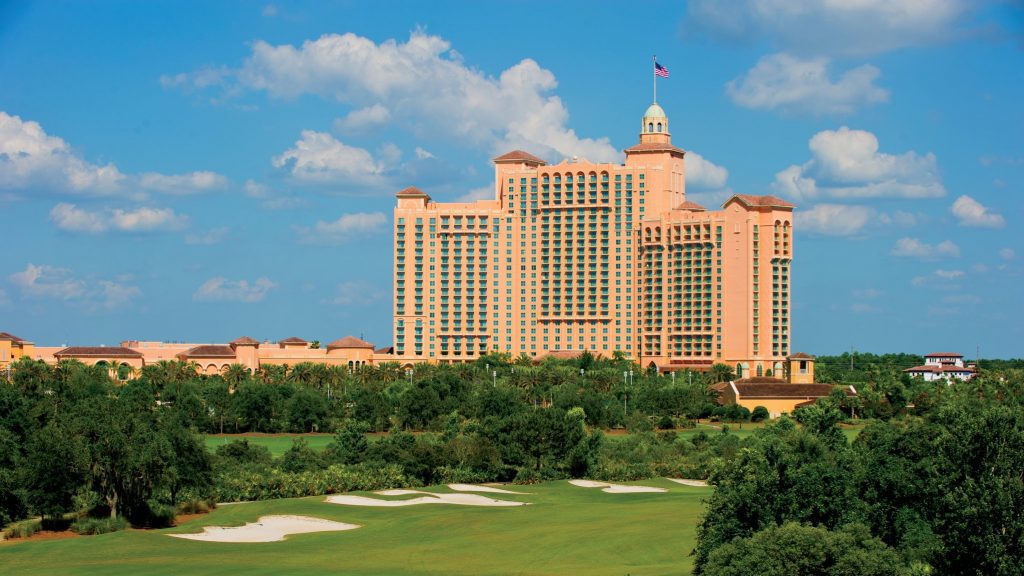 a large building with a flag on top with Atlantis Paradise Island in the background