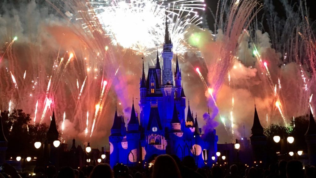 a castle with fireworks in the background