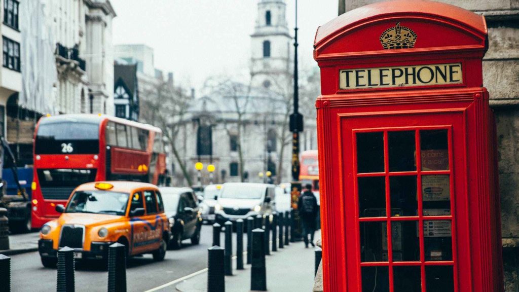 a red telephone booth on a city street