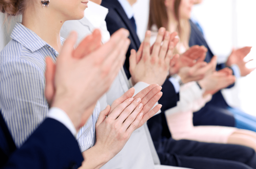 a group of people clapping hands