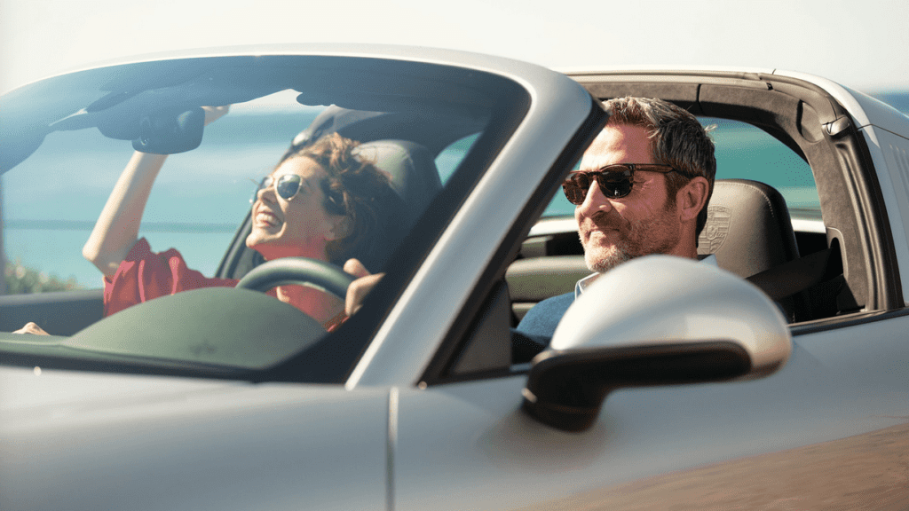 a man and woman in a convertible car