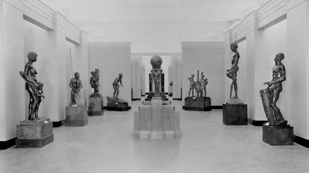 a group of statues in a museum