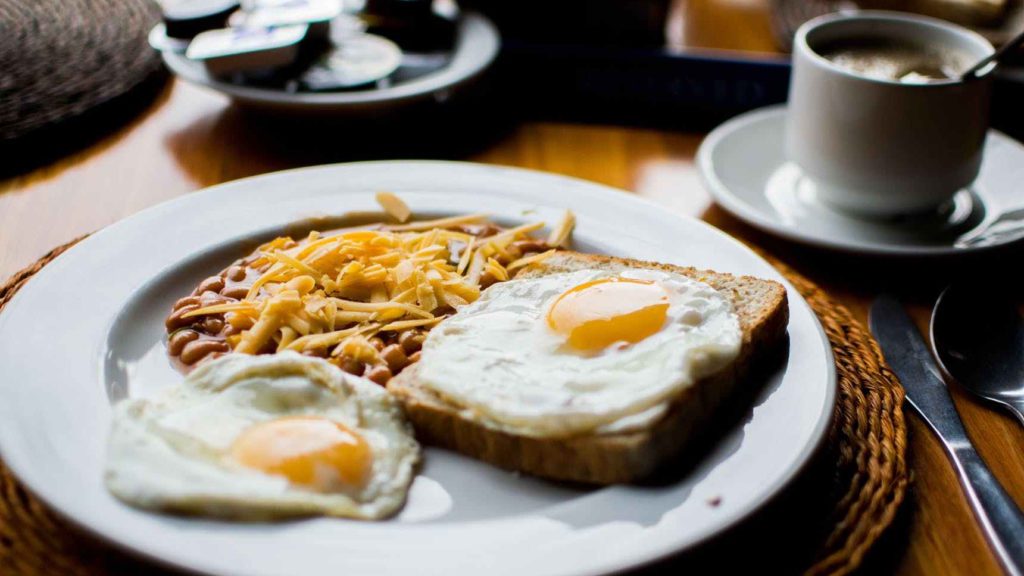 a plate of food with a fried egg and beans