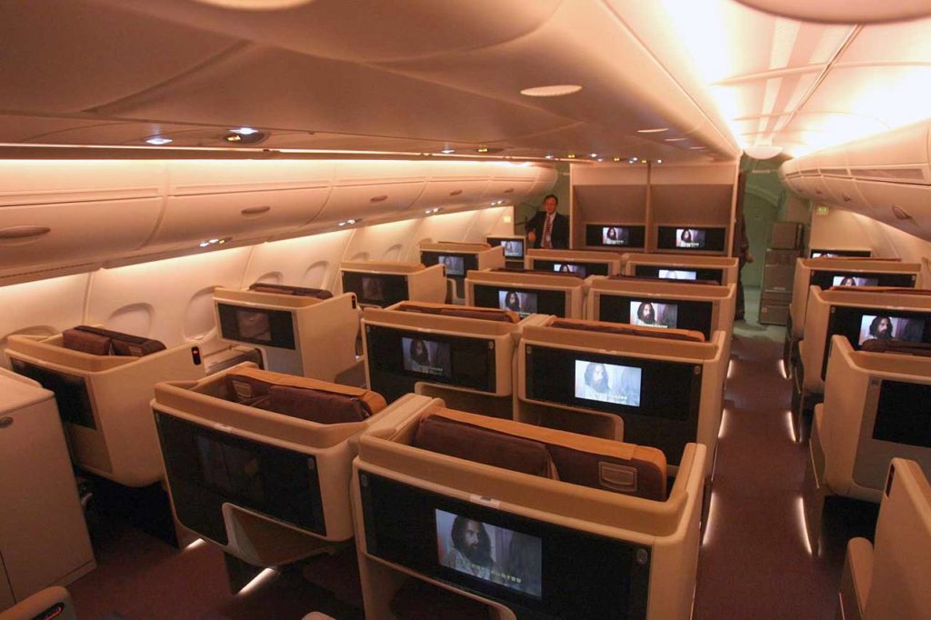 a row of seats with tvs on the back