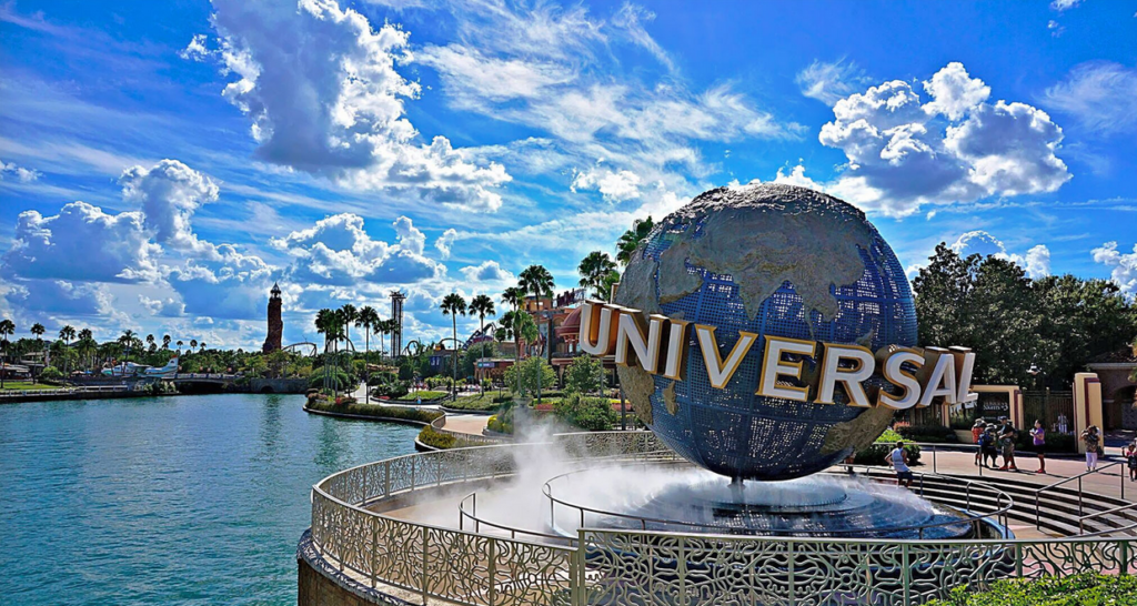 a large globe fountain with a sign on it