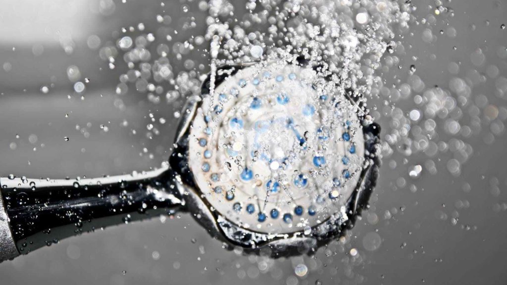 a shower head with water drops