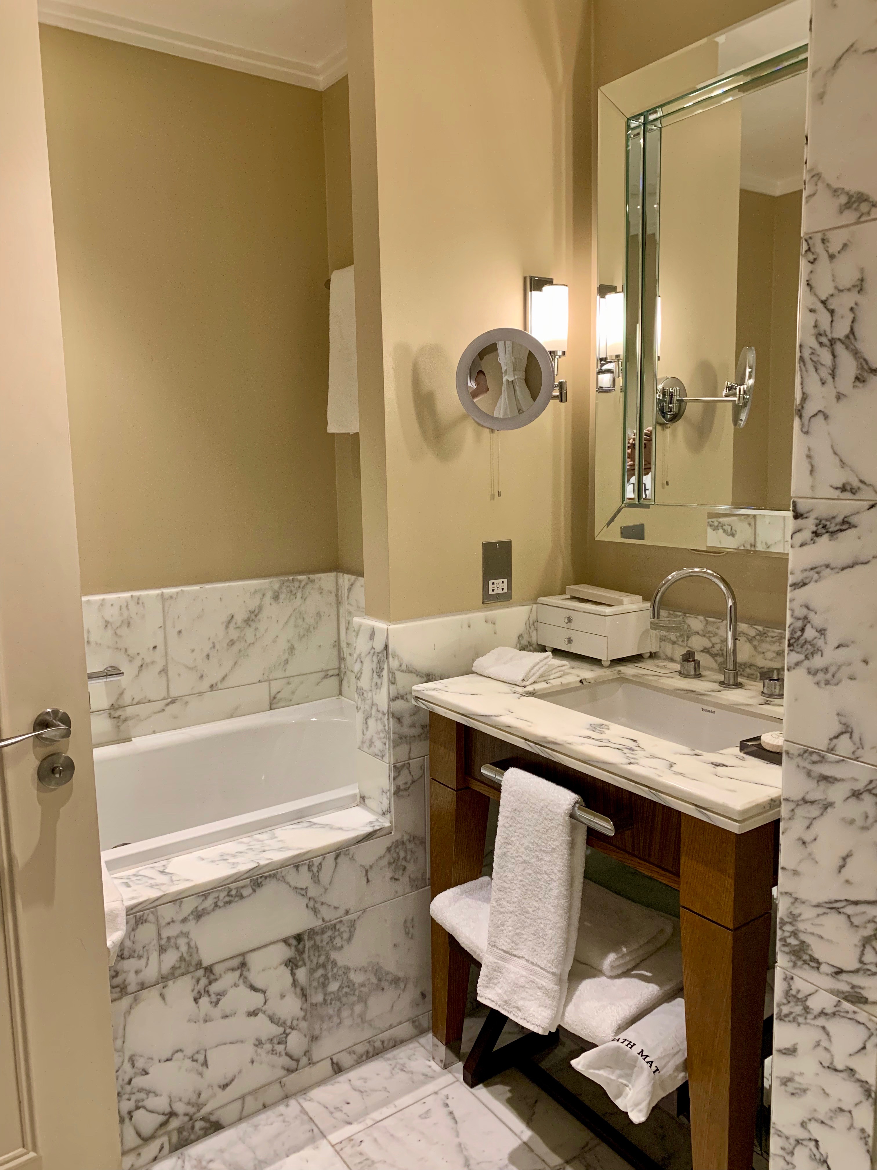a bathroom with marble walls and a sink