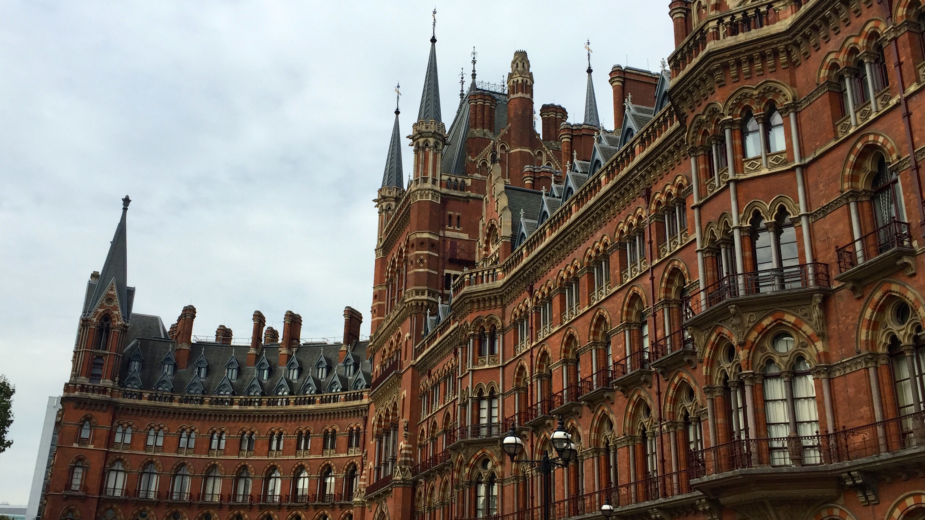 a large building with many windows with St Pancras railway station in the background
