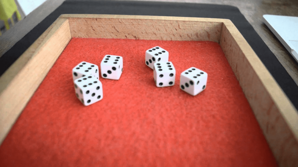 a group of dice on a red surface