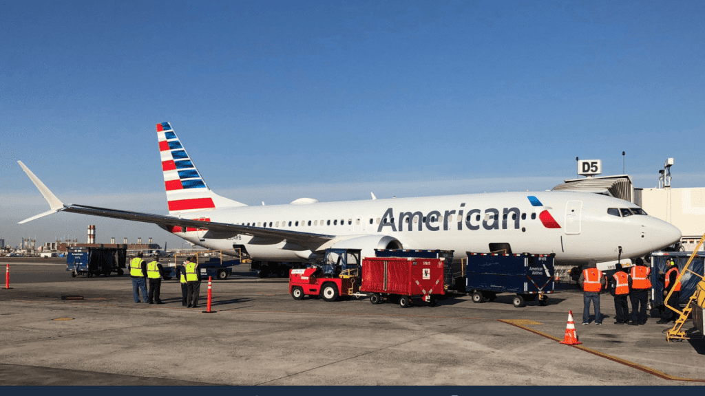 a large airplane with a red and white tail and blue text